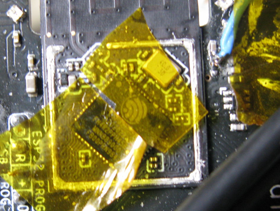 An esp32 module with it's can removed, and with tape exposing pin 5