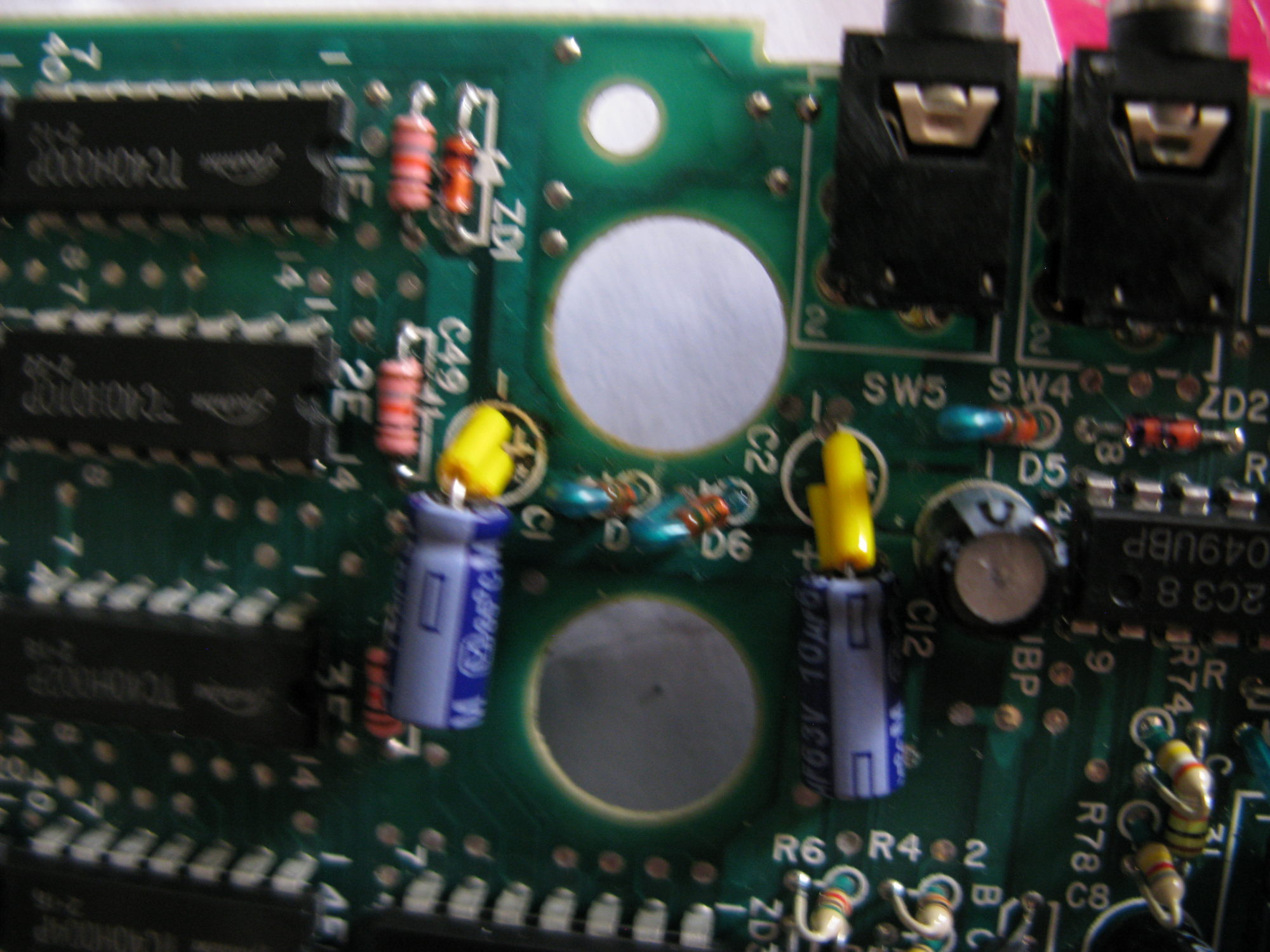 Main Epson board showing two replacement capacitors with insulated legs.